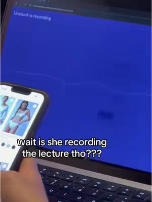 A phone displaying images of women and a laptop with a blue screen are in the foreground. A hand is holding the phone to the left. The text 'wait is she recording the lecture tho???' is overlaid on the image. The overall composition has a casual, snapshot feel.