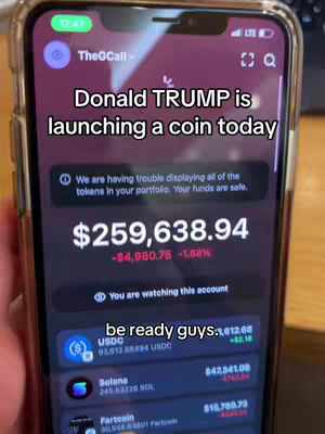 The image shows a close-up of a smartphone screen displaying a cryptocurrency portfolio with the text overlay. The screen displays an app interface with the title 'TheGCall' at the top and a message indicating that Donald Trump is launching a coin today. The screen also shows a large sum of money, with a decrease and the percentage change. Additional text appears which states: 'We are having trouble displaying all of the tokens in your portfolio. Your funds are safe'. There are also details about various cryptocurrencies (USDC, Solana, Fartcoin), showing their current values and changes. The hook text "be ready guys" is also present on the display. The color scheme is dark with highlights on the display.