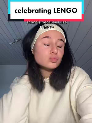 A young woman is shown in a close-up shot, wearing a white headband and a neutral-colored sweater. She is puckering her lips as if to blow a kiss, against a background of a light-colored wall. Above her, colorful text provides context for the image: 'celebrating LENGO'