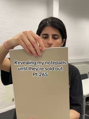 The cover image shows a person, likely the content creator, holding up a notepad in front of themselves. The person is positioned in a room setting . The text overlay reads, 'Revealing my notepads until they're sold out Pt.265'.