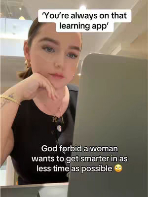 A woman is looking down with a laptop partly in the shot. Text overlays the image.