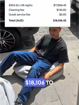A young man is sitting on a round, gray beanbag chair outside. Above him, a white box displays financial information in a list format against a dark background. Below the man and overlaid on the image is a blue rectangle that includes the text '$18,106 TO'. He is wearing a black t-shirt and blue jeans. The background shows a car.
