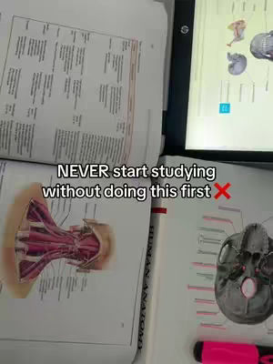The image shows a collection of open textbooks, a laptop displaying an image of a skull, and a vibrant pink highlighter, all arranged on a study surface. The composition suggests a study setup for the medical field, with anatomical illustrations visible in the open books.