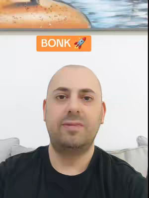 A close-up shot of a man with a shaved head looking directly at the camera. Above his head, a bright orange banner displays the word 'BONK' with a cartoon rocket emoji. The background is a plain white wall.