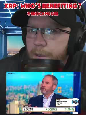 The cover image presents a split-screen effect. The foreground features a man in a cap, glasses, and a headset, positioned as if he is recording, with a microphone in front of him. Behind him, a screen is visible displaying a portion of an interview with a man, Brad Garlinghouse, on Bloomberg, and metrics below. Text overlays, in red and white, at the top read "XRP: WHO'S BENEFITING?" and "@EROCKMCGEE".