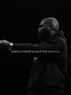 A grayscale image of a man wearing a black hoodie, turned slightly to the side, in a dark setting. Text overlayed in a faded yellow font.
