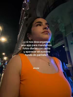 A woman in an orange top stands on a city street at night, looking upwards. Text overlays are present with a call to action. The background shows city lights and buildings.