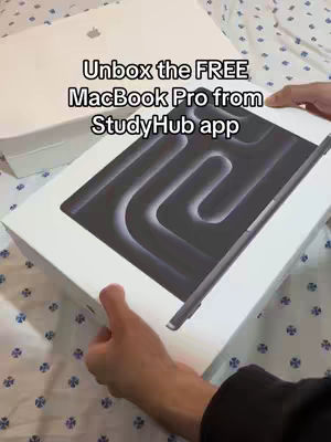 A person is shown holding a white box with a small Apple logo and another box with an image of the product and graphic, there is also an apple pencil visible. The person's hands are in the frame but the background cannot be determined.