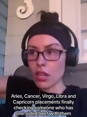 A woman with glasses and headphones looks directly at the camera. Text overlays the bottom.
