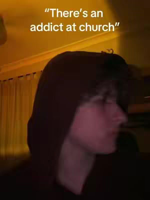 The cover image shows a young man with a hood up, viewed from the side, against a soft, warm-toned background, likely indoors. Text overlayed says, "There's an addict at church".