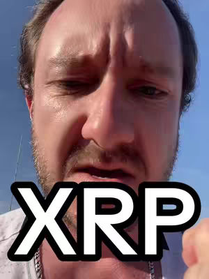 The cover image features a close-up of a man's face against a backdrop of a blue sky. The man has short, light-colored hair, and is looking down with a serious expression. Text overlayed on the image reads 'XRP' in a bold, black font with a white outline.
