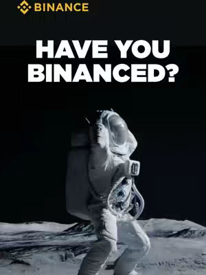 An astronaut on a stark, moon-like surface looks towards the viewer, with text overlayed. The astronaut, clad in a white spacesuit, is the central focus against a dark, starry space background, with a glowing Binance logo in the top left.