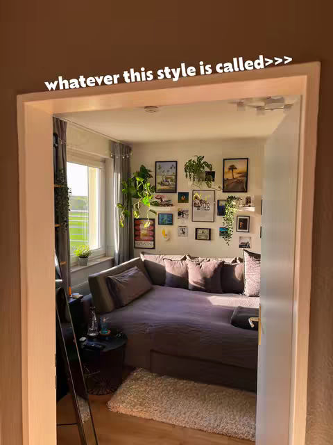 The cover image shows the interior of a bedroom viewed looking through a doorway. The bedroom walls are painted light brown, a window with sunlight is at the far side of the room, and there are several framed pictures on the back wall. In the foreground is a doorway with white trim. A text overlay in white arcs along the top edge of the frame.