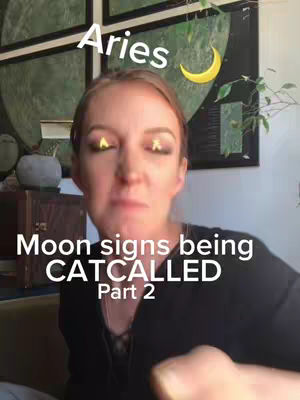 A woman with light skin and light brown hair is the focal point. Above her head, the word "Aries" is written in a white, rounded font. In the background, there is an abstract painting with a yellow crescent moon graphic. The text "Moon signs being CATCALLED Part 2" is written in white, sans-serif font below her face, with "Part 2" in a smaller font below.