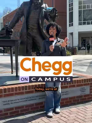 A presenter wearing a blazer and jeans stands in front of a brick structure with a statue in the background. A large "Chegg ON CAMPUS" graphic covers the area in front of her, with "Today, we're at" in a banner below it.