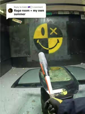 An interior shot of a building with smashed windows. A person holding the baseball bat is in the foreground.
