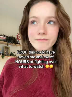 A young woman with long brown hair and blue eyes is looking at the camera with a slightly concerned expression. She is wearing a red sweater. Text overlayed on the image reads: "BRUH this could have saved me and my bf HOURS of fighting over what to watch". The background is a softly lit interior with a shelf holding books and decorative items.