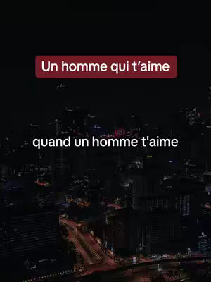 The cover image shows a night cityscape with text overlays. The background is a dark view of tall buildings reflecting city lights, creating a sense of depth. Two text boxes are placed on the image. The top text is a burgundy rectangle with white text that reads "Un homme qui t’aime." The bottom text is also white and reads "quand un homme t’aime." Overall, the image has a dark, romantic aesthetic.