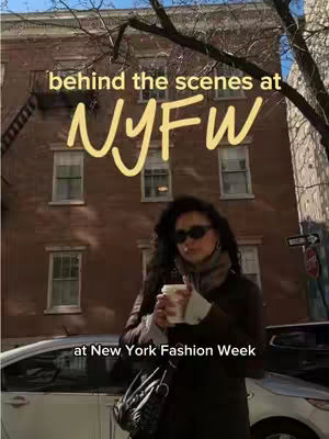 A woman in sunglasses stands with a coffee cup in front of a brick building during New York Fashion Week. Overlay text reads 'behind the scenes at NYFW'.