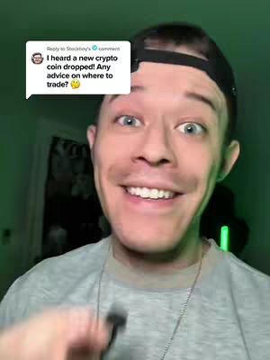 A man with light skin is the central focus, looking directly at the camera with a slight smile. A speech bubble in the upper-left corner contains text. The background is a room and dark.