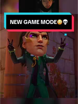 The cover image is a vertical composition featuring a superimposed exaggerated character's head, taking up most of the space. The character has an animated face with a green skin and yellow-gold accents, wearing a green outfit and giving a peace sign. Above the character, there is a cut out from a live recording, showing a person's face from the top. At the center of the image, there is a black rectangle that includes the text "NEW GAME MODE" in white and a skull and startled face emoji.