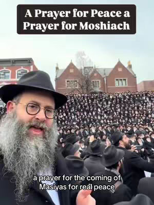 The cover image shows a man with a beard smiling and speaking directly to the camera. He wears glasses and a hat. Behind him is a large crowd of people, presumably at an outdoor event. Above the man's head is a black banner with white text. The overall impression is of a religious or community gathering.