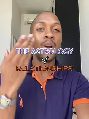 A man with closely shaven hair and a small beard, wearing a navy blue polo shirt, is the central focus. Text overlay across the image reads 'The Astrology of Relationships' in a layered font. The man is gesturing towards the camera with his right hand as if presenting or blowing a kiss.
