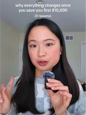 The cover image features a woman with long dark hair, holding a small microphone in one hand and making a peace sign with the other. Text overlays the top, with a blurred background of a room.