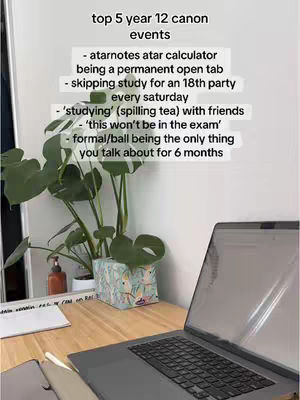 A top-down shot of a wooden desk with a laptop, a plant, and other objects on it. The text is written in a rectangular white box in the image.