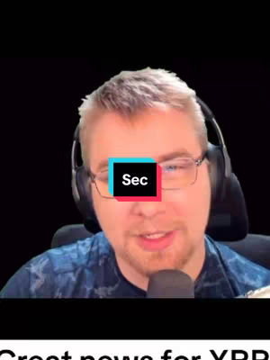 A man with glasses and a headset is centered in front of a black background. A colored box with the text "Sec" is overlayed at his eye level.  He appears to be speaking into a microphone.