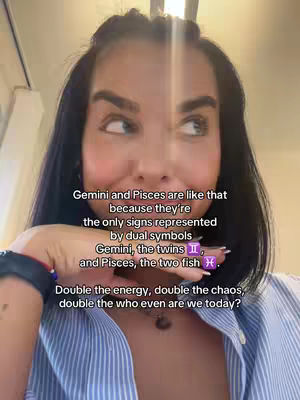 A woman with dark hair and fair skin is looking up and slightly to the side, as if pondering or thinking. The background is somewhat blurred, likely an interior setting. Overlaid on the image is a text overlay that describes the zodiac signs Gemini and Pisces.