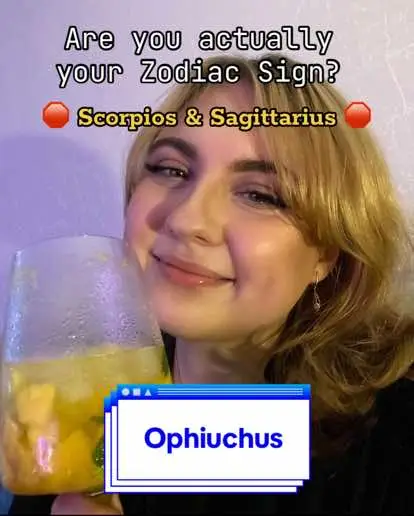 A young woman poses for the camera, holding a glass of a yellow beverage. Text overlays name and describes the zodiac sign Ophiuchus. The background is blurred with a mix of colors creating a soft ambiance.