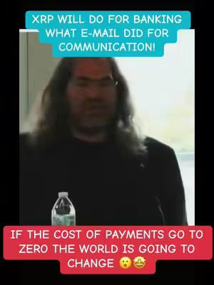 The image shows a man with long hair in a black top speaking in front of a basic white background. Added as text overlay it has two colored bars with motivational words. At the bottom is a red bar with an emoji.