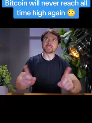 A man in a black t-shirt is centered, gesturing with both hands. Above him in a blue rectangle is white text. The setting appears to be a room with some plants on the right and a small potted plant on the left.