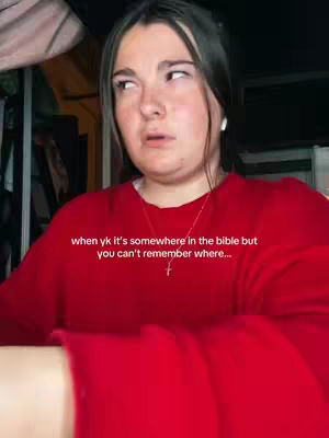 A young woman with dark hair and a red sweater looks up and to the side with a confused expression. Text overlayed on the image reads: 'when yk it's somewhere in the bible but you can't remember where...'
