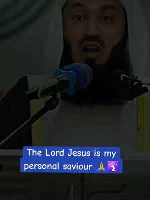 A man wearing a white head covering is speaking into a microphone. Overlayed on the image is a blue rectangle with white text that reads, "The Lord Jesus is my personal saviour" followed by an emoji of praying hands and a home icon.