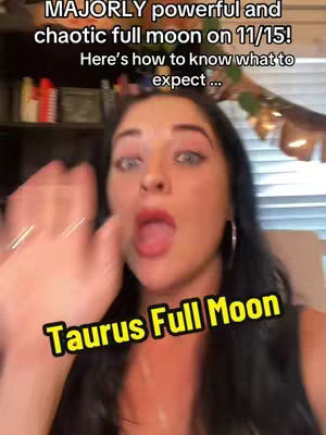 A woman with dark hair and fair skin is centered in the frame, her mouth open in a surprised or excited expression. The background is out of focus.