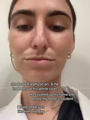 A close-up selfie focuses on a young woman's face, with a gentle expression and slightly downward gaze. She wears hoop earrings. Text overlays reveal text in black font against the white background.