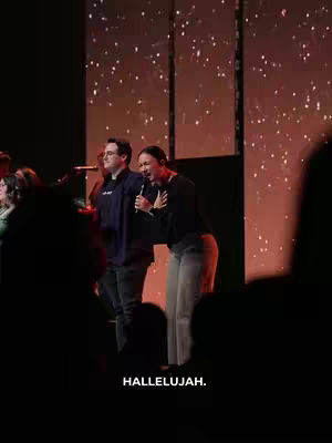 The cover image shows a stage with people on it. Two people, a man and a woman, are lit up in the middle, with a spotlight on them. The woman is singing with the microphone in her right hand while the man is looking straight ahead. The text at the bottom says "HALLELUJAH."