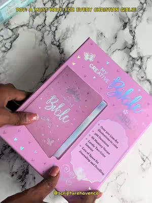 The cover image shows a person holding a pink box. The box contains a pink Bible with the title 'My Creative Bible' in a sparkly font. The box has a cutout that reveals the Bible inside, and text overlays describe the Bible's features, like journaling space and illustrations. The background features a marble-like surface.