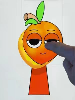The image is a cartoon-style illustration of a fruit, possibly a banana or a hybrid. The central figure appears to be an orange-colored oval with a face, including closed eyes and a small, curved mouth, giving it a slightly playful or relaxed expression. A green upward-curving shape with a leaf-like element on the side appears on top of the orange shape. To its side there is a yellow shape. A finger of a hand is touching the fruit's face, suggesting interaction or commentary. The overall design is simple and colorful against a plain white background.