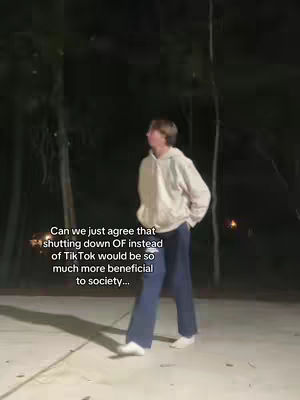 A person wearing a hoodie and dark pants is walking away from the camera in a dark, outdoor setting. Text is overlaid on the image.
