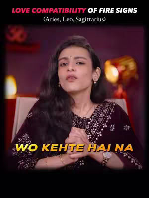 The cover image features a woman in a close-up shot, with text overlays at the top and bottom. The woman has long, wavy dark hair and is wearing a dark embroidered top. She is positioned centrally, with her hands clasped near her chest. The background is a warm, blurry mix of reds and oranges, suggesting an indoor setting with soft lighting. The text at the top reads 'LOVE COMPATIBILITY OF FIRE SIGNS' followed by '(Aries, Leo, Sagittarius)' and at the bottom there's text in a golden font.