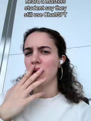 A woman with dark curly hair is looking towards the camera while holding her hand up to her mouth. Text is overlaid at the top.