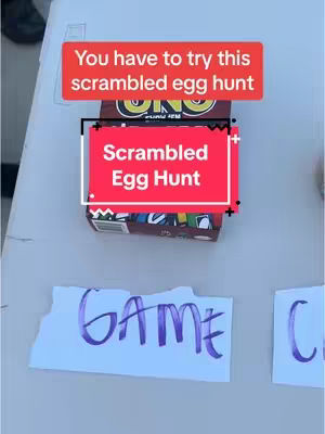 A top-down shot of a table with a box of UNO cards and some handwritten signs, indicating the start of an Easter egg hunt. Text overlays describe the event. The scene has a casual, inviting feel.