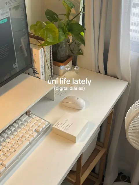 A well-lit, minimalist desk setup with a computer, keyboard, mouse, and a small plant in a glass jar. A notepad with handwritten notes sits on the desk. Soft curtains and muted colors create a calm and organized atmosphere. The words "uni life lately (digital diaries)" are written in the bottom center.