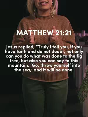 A woman stands from the midriff up facing the camera. She has short blonde hair and is wearing a brown sweater and green pants. The text overlay reads: MATTHEW 21:21 Jesus replied, “Truly I tell you, if you have faith and do not doubt, not only can you do what was done to the fig tree, but also you can say to this mountain, ‘Go, throw yourself into the sea,’ and it will be done.