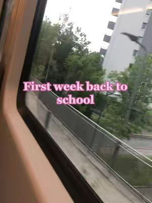 The cover image is a view from a train or bus window, showing the exterior of a building and some trees. The sky is overcast. The image is framed by the window.