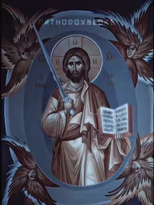 An artistic rendering of a religious figure facing forward, holding a sword in his right hand and an open book in his left. He is framed by an ethereal blue oval with three angel-like figures surrounding him. Above the figure is a golden halo, behind which is a circular inscription. The central figure is dressed in brown and beige robes, and the overall style has a traditional, almost iconographic quality.