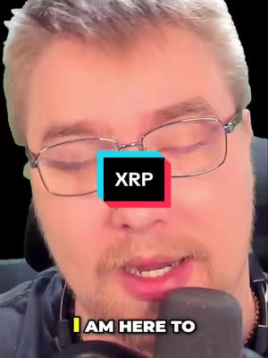 A man is centered in the frame, appearing close-up from the chest up. He has short, light-colored hair, wears eyeglasses and a beard; a microphone is close to his mouth. "XRP" is written on a box over his face with some other text below, and the background is a vague, almost black darkness. The overall composition has a slightly warm tone.